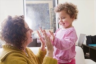 Mother and daughter playing clapping game
