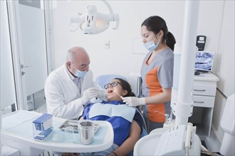 Teenage girl getting dental cleaning