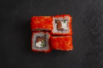 Red fish roe sushi on black surface