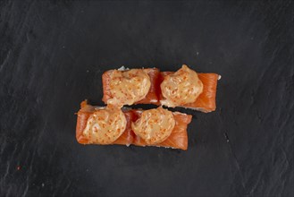 Salmon sushi with orange sauce