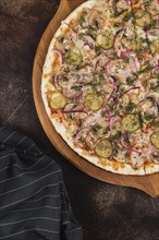 Pizza with pickles and red onion