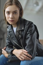 Young woman wearing black leather jacket