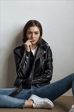 Young woman wearing black leather jacket