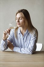 Young woman with glass of white wine