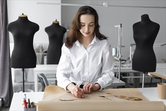 Fashion designer working at desk in studio