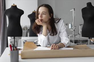 Fashion designer thinking at desk