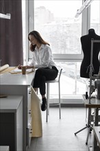 Fashion designer working at desk in studio