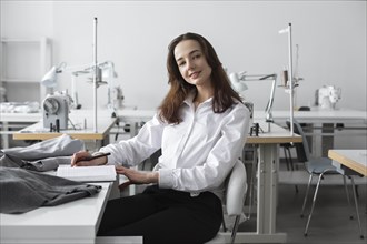Fashion designer sitting at desk in studio
