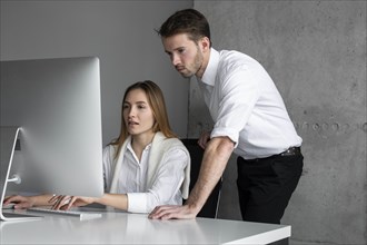 Businesspeople using computer together