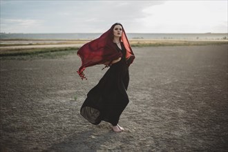 Windswept woman wearing red headscarf