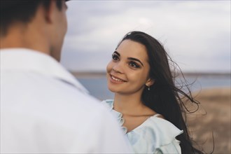 Smiling young woman looking at her partner