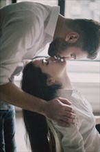 Young couple face to face with their eyes closed