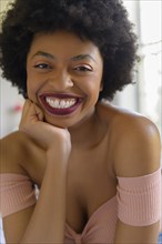 Portrait of smiling young woman wearing lipstick