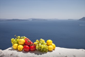 Fruit on white wall by sea