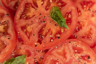 Sliced tomatoes with basil and pepper