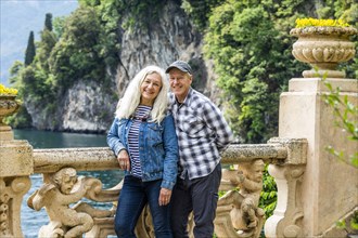 Smiling couple at Villa del Balbianello by Lake Como, Italy