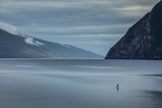 Man paddleboarding on Lake Garda, Italy
