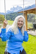 Mature woman smiling on swing