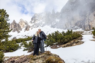Couple hiking on Giau Pass in Dolomites, Italy