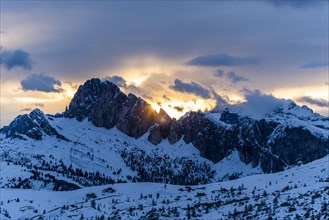 Mountain range in snow at sunset in Dolomites, Italy