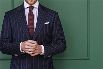 Man wearing pinstripe blazer with spotted tie