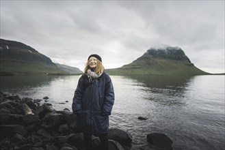 Smiling woman by Kirkjufell in Iceland