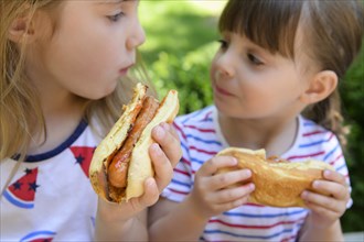 Girls eating hot dogs