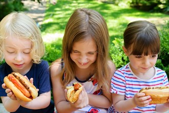 Children eating hot dogs