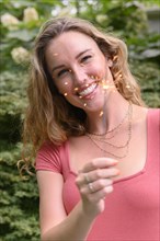 Smiling young woman holding sparkler