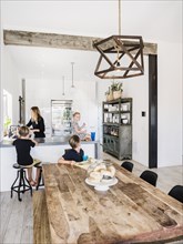 Mother and children in kitchen and dining room