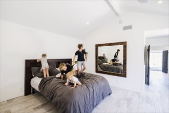 Children jumping on bed