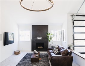 Living room with leather sofa and fireplace