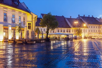 Wet Grand Square at sunset in Sibiu