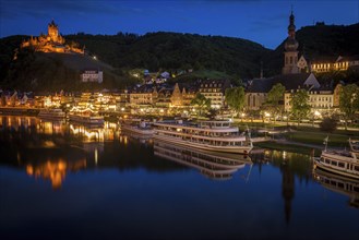 Town and Cochem Imperial Castle by river at sunset in Cochem