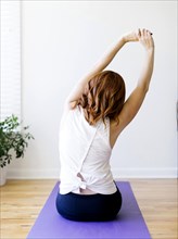 Rear view of woman practicing yoga