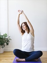 Mid adult woman practicing yoga