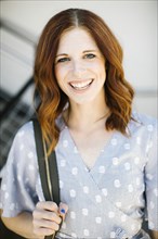Smiling mid adult woman with red hair