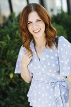 Smiling mid adult woman wearing patterned blouse