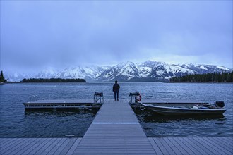 Woman standing on jetty on Jenny Lake in Grand Teton National Park