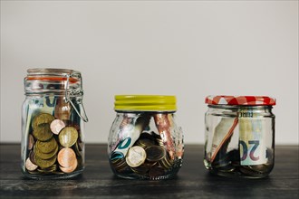 Euro currency in glass jars