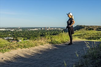 Mature woman hiking by grass in Boise