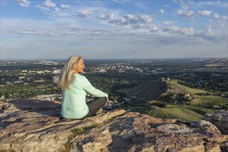 Mature woman sitting on rocks in Boise