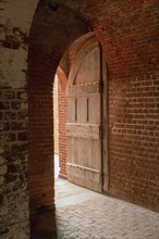 Open door and brick wall