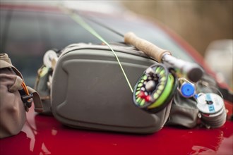 Fishing rod and bags on car