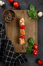 Grilled chicken and tomato skewer on cutting board