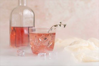 Pink cocktail with ice cubes