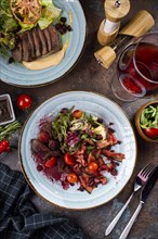 Two beef salads with red wine