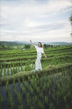 Woman walking in rice paddy in Bali