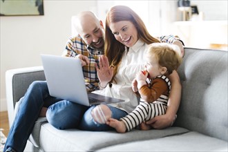 Family using laptop to video chat