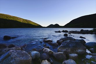 Rocks in Jordan Pond by hills in Acadia National Park, Maine, USA